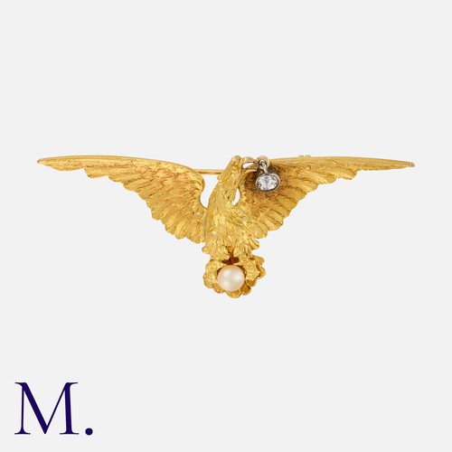 179 - A Pearl and Diamond Brooch in yellow gold, designed as a bird with a pearl in it's talons and a diam... 