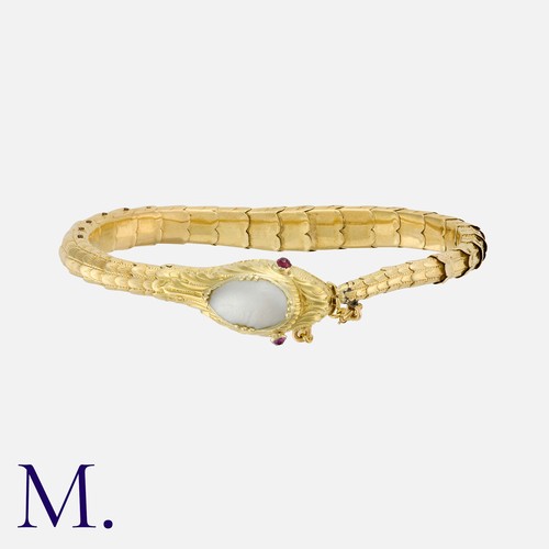180 - An Antique Snake Bracelet in yellow gold in an articulating form with a nacre-set head and ruby-set ... 