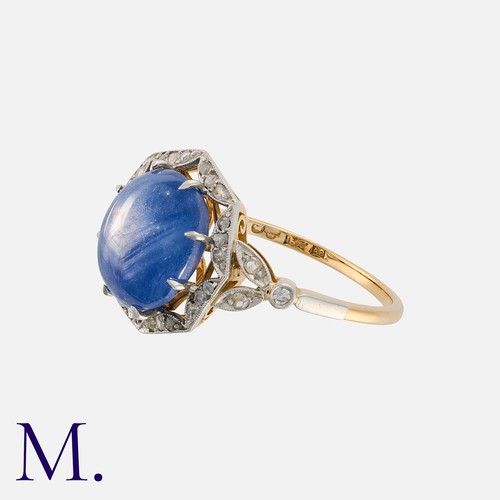62 - An Unheated Ceylon Star Sapphire and Diamond Ring in 18 carat yellow gold, set with a principal cabo... 