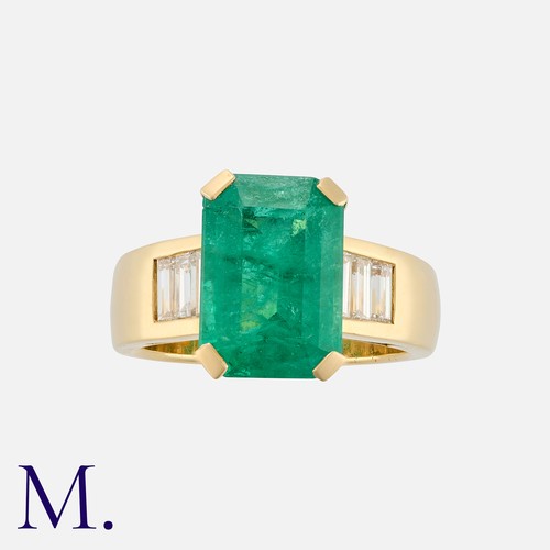172 - An Emerald and Diamond Ring in yellow gold, comprising an elongated octagonal emerald of approximate... 