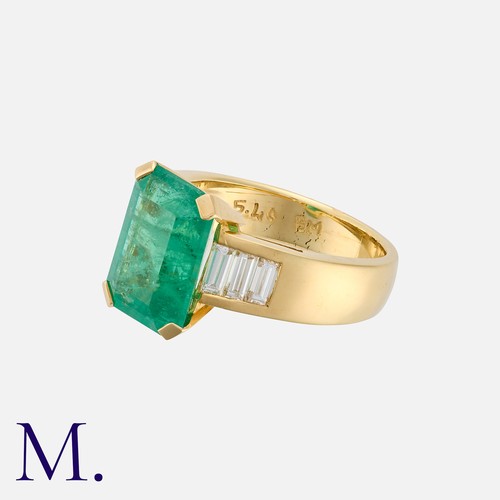 172 - An Emerald and Diamond Ring in yellow gold, comprising an elongated octagonal emerald of approximate... 