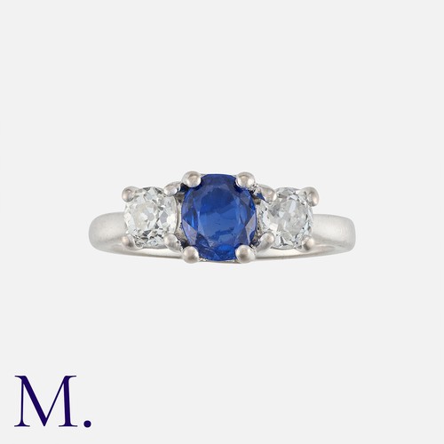 159 - A Sapphire and Diamond 3-Stone Ring in 18K white gold with an oval cut sapphire to the centre with o... 