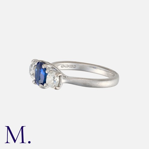 159 - A Sapphire and Diamond 3-Stone Ring in 18K white gold with an oval cut sapphire to the centre with o... 
