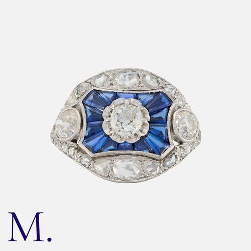 123 - A Diamond and Sapphire Ring set with three principal old cut diamonds with calibrated sapphires and ... 