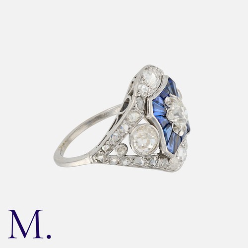 123 - A Diamond and Sapphire Ring set with three principal old cut diamonds with calibrated sapphires and ... 