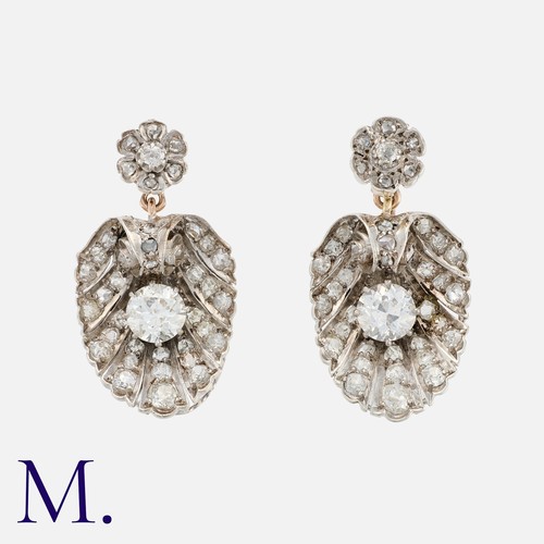 165 - A Pair of Old Cut Diamond Earrings in gold and silver, each comprising a floral diamond set top, sus... 