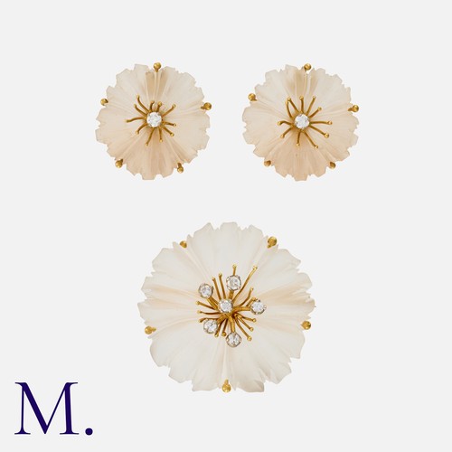 125 - A Carved Rock Crystal and Diamond Earring and Brooch Set in 18 carat gold, comprising a carved , foo... 