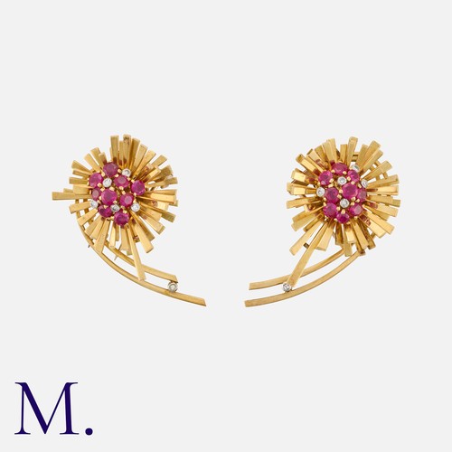 130 - A Pair of Ruby and Diamond Clip Brooches in yellow gold, each of abstract floral form, set with roun... 