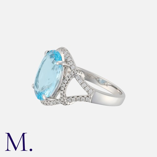 24 - An Aquamarine and Diamond Ring in white gold, set with an oval-cut aquamarine weighing 5.07ct with r... 
