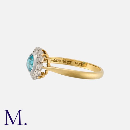 14 - A Zircon and Diamond Cluster Ring in 18 carat gold and platinum, set with a principal round cut zirc... 