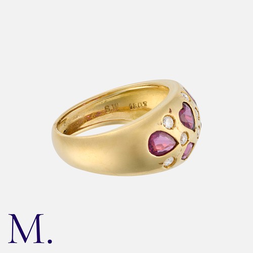 106 - A Ruby and Diamond Bombé Ring in 18 carat yellow gold, set with variously cut rubies and round cut d... 