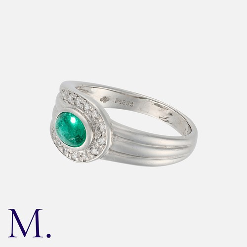 103 - An Emerald and Diamond Ring in platinum, set with a cabochon emerald of approximately 0.56 carats, a... 