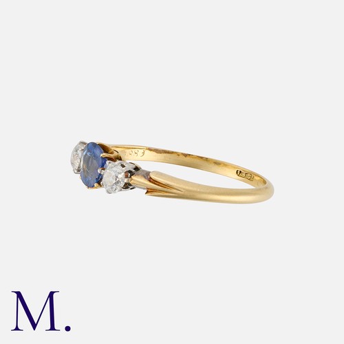 137 - A Sapphire and Diamond Three Stone Ring in 18 carat yellow gold. Set with a principal cushion cut sa... 