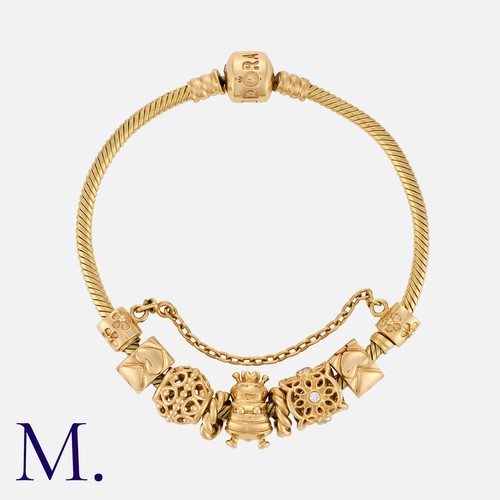 153 - PANDORA, A Charm Bracelet in 14 carat yellow gold, the snake link bracelet adorned with a series of ... 