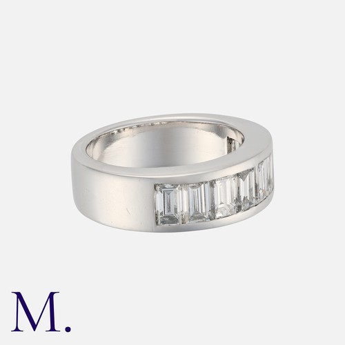 52 - A Diamond Half Eternity Ring in white gold, set with a row of nine step cut diamonds totalling appro... 