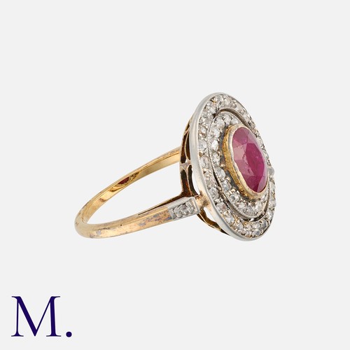 42 - A Ruby and Diamond Cluster Ring 18K gold, set with an oval cut ruby to the centre of two concentric ... 