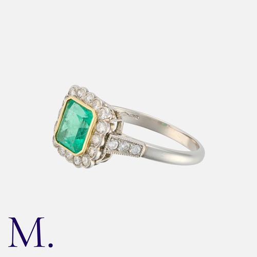 138 - An Emerald and Diamond Ring in platinum and yellow gold, set with a rectangular cut emerald weighing... 