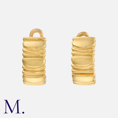 129 - CARTIER. A Pair of Baignoire Hoop Earclips in 18K yellow gold, signed Cartier and serial numbered.  ... 