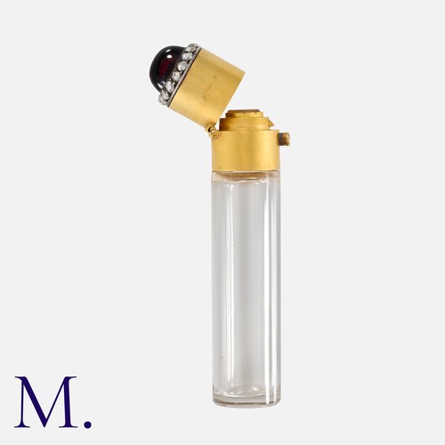 43 - A Fine Antique French Perfume Bottle in 18 carat yellow gold, the cylindrical glass scent bottle, wi... 