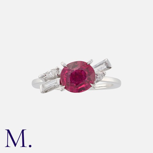 177 - A Rubellite Tourmaline and Diamond Ring in white gold. Set with a principal cushion cut rubellite to... 