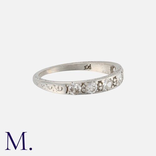 242 - A Diamond Band, in platinum, set with a row of six round cut diamonds. Marked indistinctly PT.

Size... 