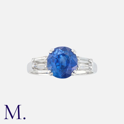 243 - A Sapphire And Diamond Ring in white gold, set with a round cut sapphire of approximately 3.10ct bet... 
