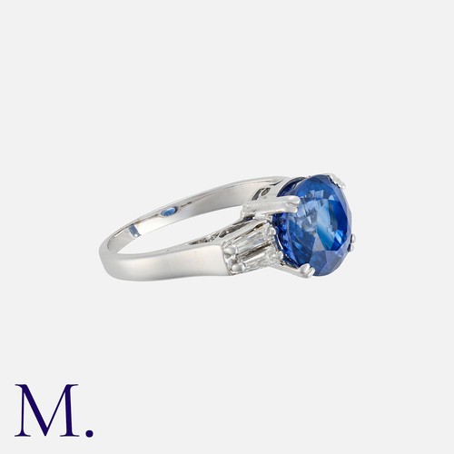 243 - A Sapphire And Diamond Ring in white gold, set with a round cut sapphire of approximately 3.10ct bet... 