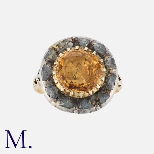 116 - A Georgian Topaz and Diamond Ring in yellow gold and silver, the round-cut topaz in a closed-back cu... 