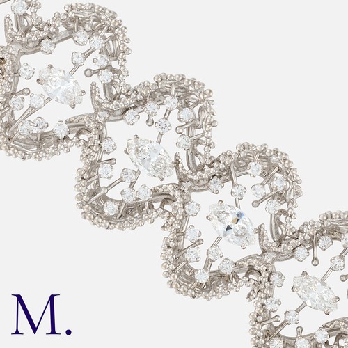 69 - JOHN DONALD, A Modernist Diamond Bracelet in 18 carat white gold, comprising ten abstract textured l... 