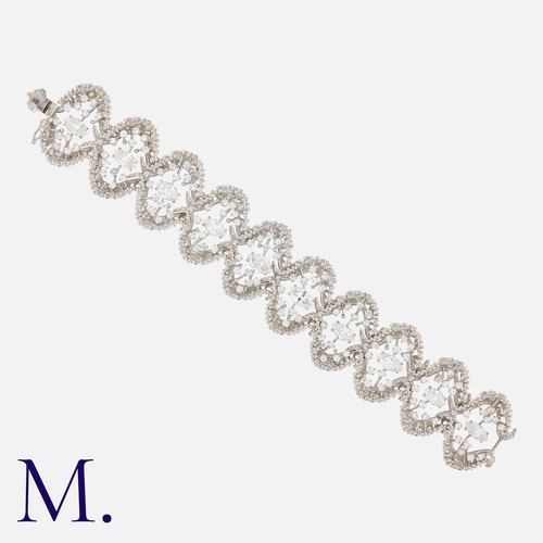 69 - JOHN DONALD, A Modernist Diamond Bracelet in 18 carat white gold, comprising ten abstract textured l... 