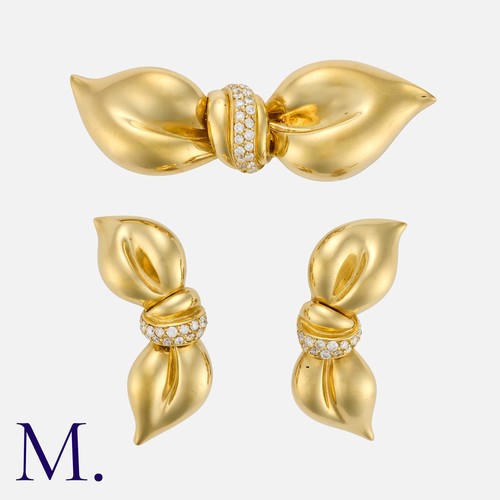 117 - A Diamond Brooch and Earring Suite in 18 carat yellow gold, comprising a brooch designed as a bow, s... 