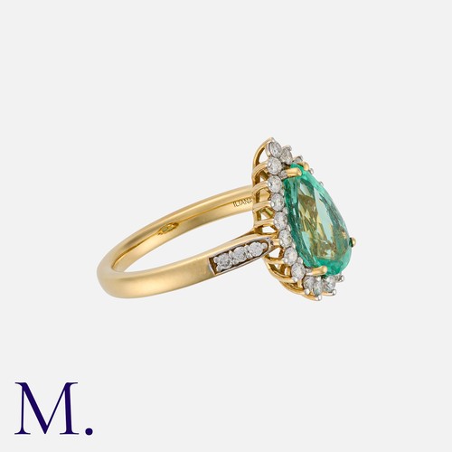 62 - An Emerald and Diamond Cluster Ring in 18K yellow gold, set with a pear-cut emerald weighing approx.... 