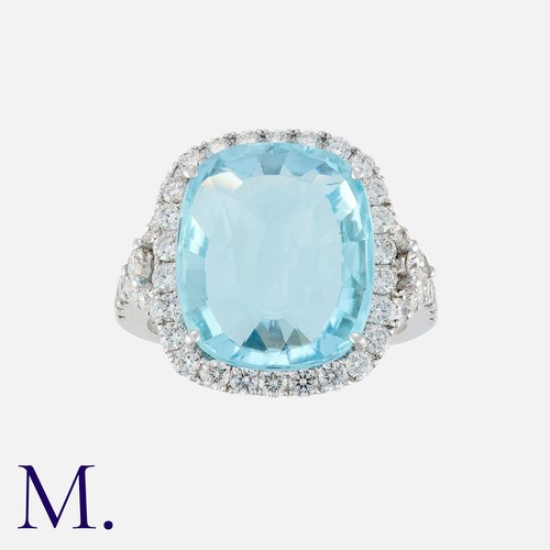 118 - An Aquamarine and Diamond Cluster Ring in 18 carat white gold, set with a principal aquamarine of ap... 