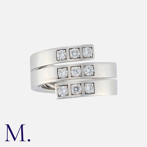 112 - CARTIER, A Diamond Ring in 18 carat white gold, comprising a single coiled bad set with nine round b... 