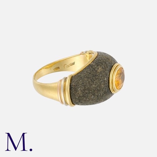 120 - CARTIER. A Citrine and Hardstone Ring in 18K yellow gold, bezel set with an oval cut citrine inset t... 