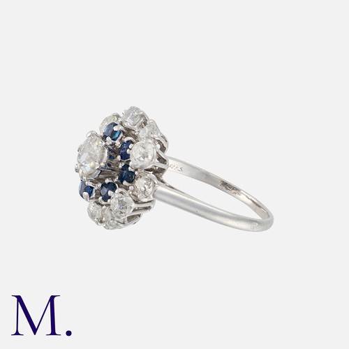 74 - CHAUMET. A Sapphire and Diamond Cluster Ring in platinum, set with an old cut diamond to the centre ... 