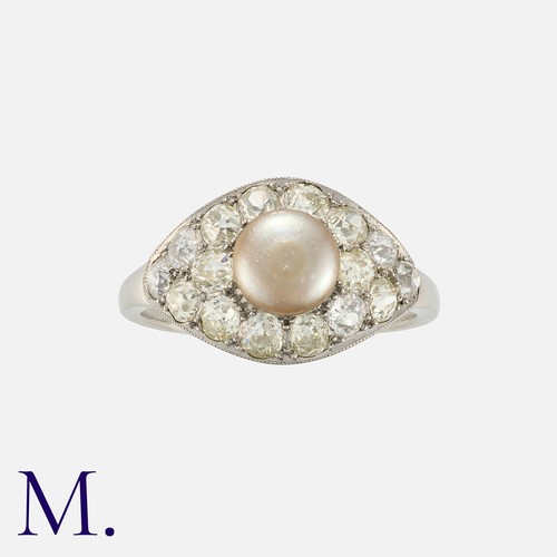 105 - An Art Deco Pearl and Diamond Ring in platinum, set with a button shaped grey pearl measuring approx... 