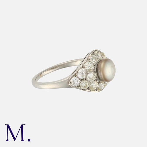 105 - An Art Deco Pearl and Diamond Ring in platinum, set with a button shaped grey pearl measuring approx... 