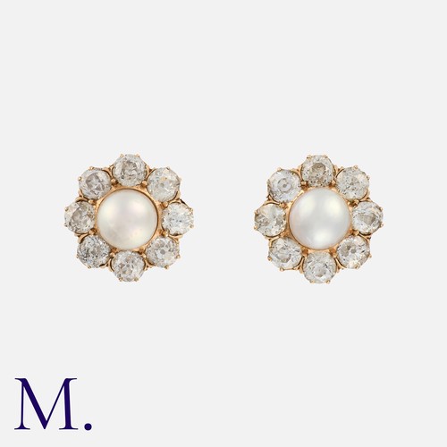 66 - A Pair of Natural Pearl and Diamond Cluster Earrings in yellow gold, each comprising a natural pearl... 