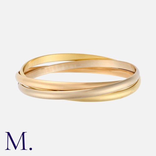 107 - CARTIER. A Trinity Bangle in 18K yellow, white and rose gold of interlocking bangle design (each app... 