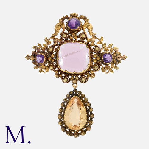 79 - An Antique Cannetille Topaz and Amethyst Brooch, in yellow gold, set with a principal cushion cut pi... 