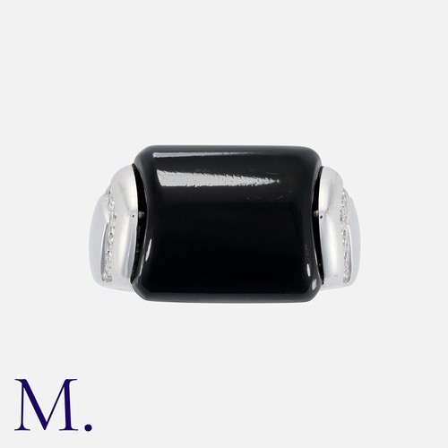 98 - BULGARI. An Onyx and Diamond Tronchetto Ring in 18K white gold set with a principal polished onyx wi... 