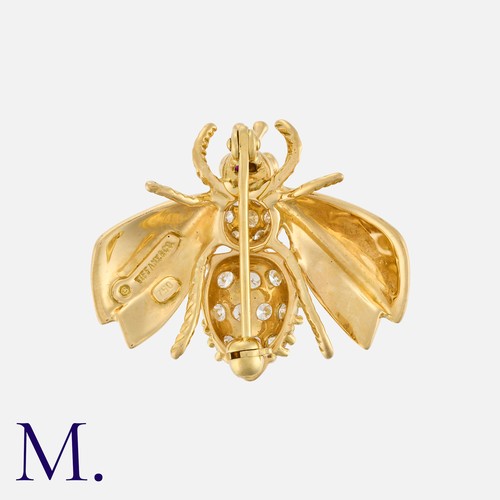 82 - TIFFANY & Co., A Diamond and Ruby Bee Brooch, in 18k yellow gold, designed as a bee, the body set wi... 