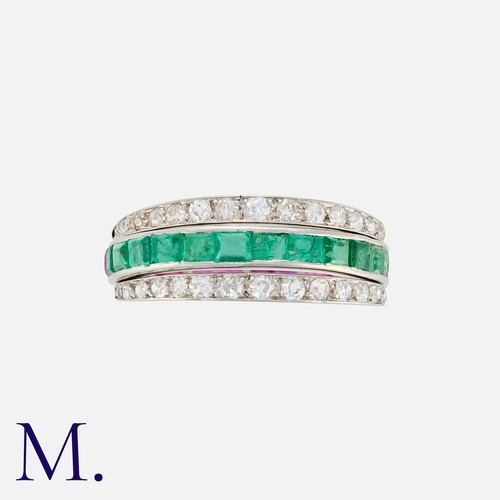 110 - A Reversible Ruby, Emerald And Diamond Ring in white gold, set to one side with a row of calibre cut... 