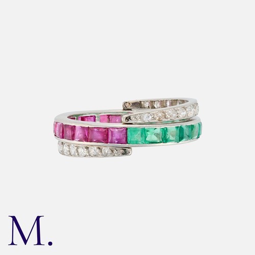 110 - A Reversible Ruby, Emerald And Diamond Ring in white gold, set to one side with a row of calibre cut... 