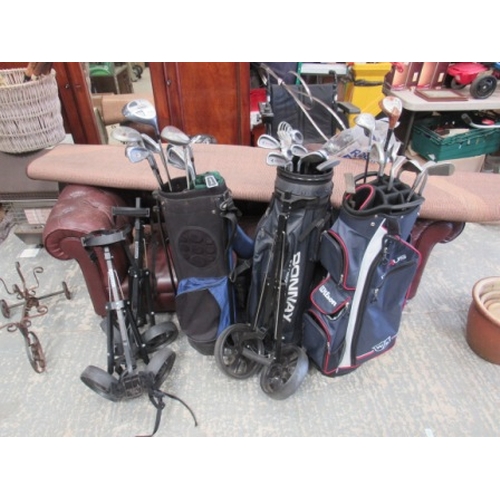 34 - 3 golf bags, trollys and clubs