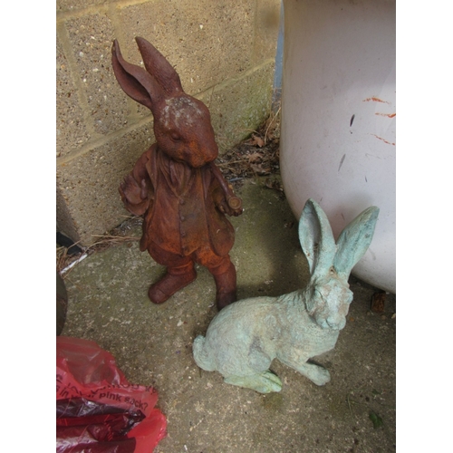 323 - 2 Cast iron rabbits