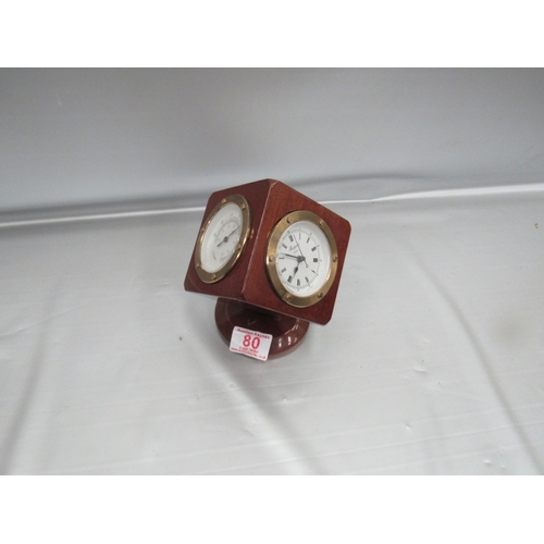 80 - Rotatry desk top clock/ barometer