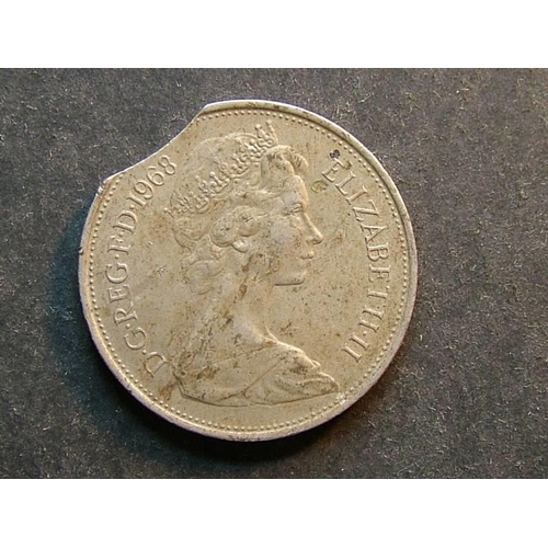 371 - Ten Pence.  1968, VF, dirty, small scratches.  Minting error; small flan clip.