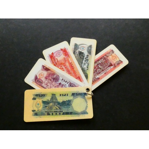 77 - FIJI.  Souvenir keychain fob, with reproductions of Fiji $1, $2, $5, $10, and $20 banknotes, 1974 is... 